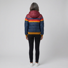 Mila rainbow stripe hooded puffer jacket in navy, back view on model