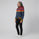 Mila rainbow stripe hooded puffer jacket in navy, side view on model