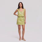 Lime green linen co-ord set with cream bandana print — sleeveless cropped vest top and matching mini skirt, full-length front view