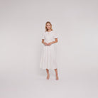 White cotton midi dress with keyhole neckline, full-length on model
