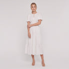 White tiered cotton midi dress, side pose on model