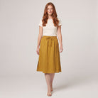 Mustard yellow linen A-line knee-length drawstring skirt, front view on model