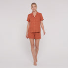 Rust orange linen camp-collar shirt and high-waist shorts set, front view on model