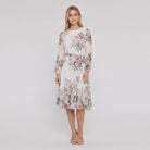 Model wearing white floral A-line midi dress with tie belt, front view