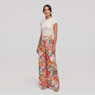 Pamela Boutique pink floral wide-leg flared trousers, model angle pose