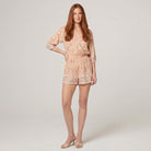 Beige floral playsuit V-neck three-quarter sleeve, model standing - Pamela Boutique