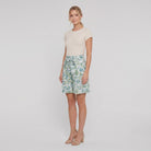 Pamela Boutique mint floral pleated shorts, model angle pose