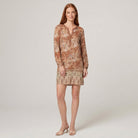 Model wearing brown floral V-neck long-sleeve shift mini dress, front view