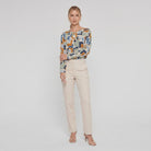 Pamela Boutique geometric print crew blouse, model side pose