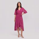 Fuchsia pink Gina wrap midi dress with V-neck and flutter sleeves on model