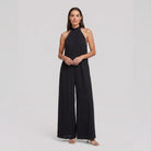 Black halter neck wide leg jumpsuit on model, front pose - Pamela Boutique