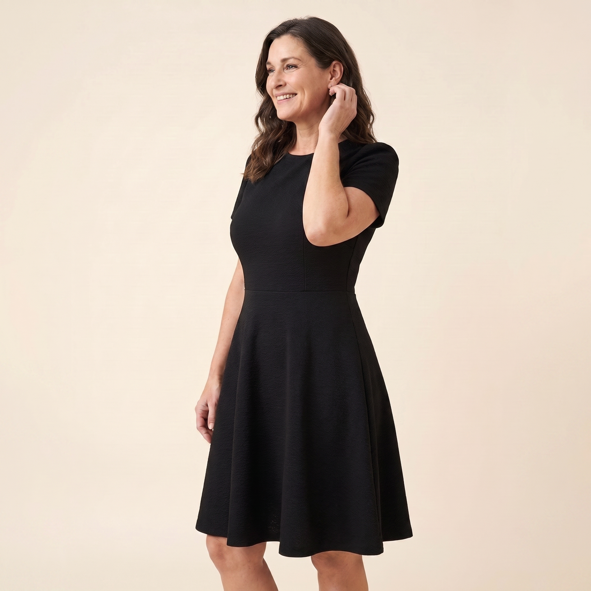 Ivy Midi Dress in black textured crepe, model three-quarter side view — side
