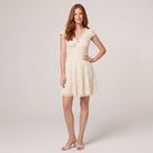 Cream ivory lace mini dress with black polka dot print, V-neck cap sleeves, front view