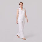 White wide-leg linen jumpsuit, walking pose on model