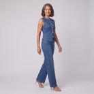 Indigo denim two-piece set with gold buttons, side walking view on model