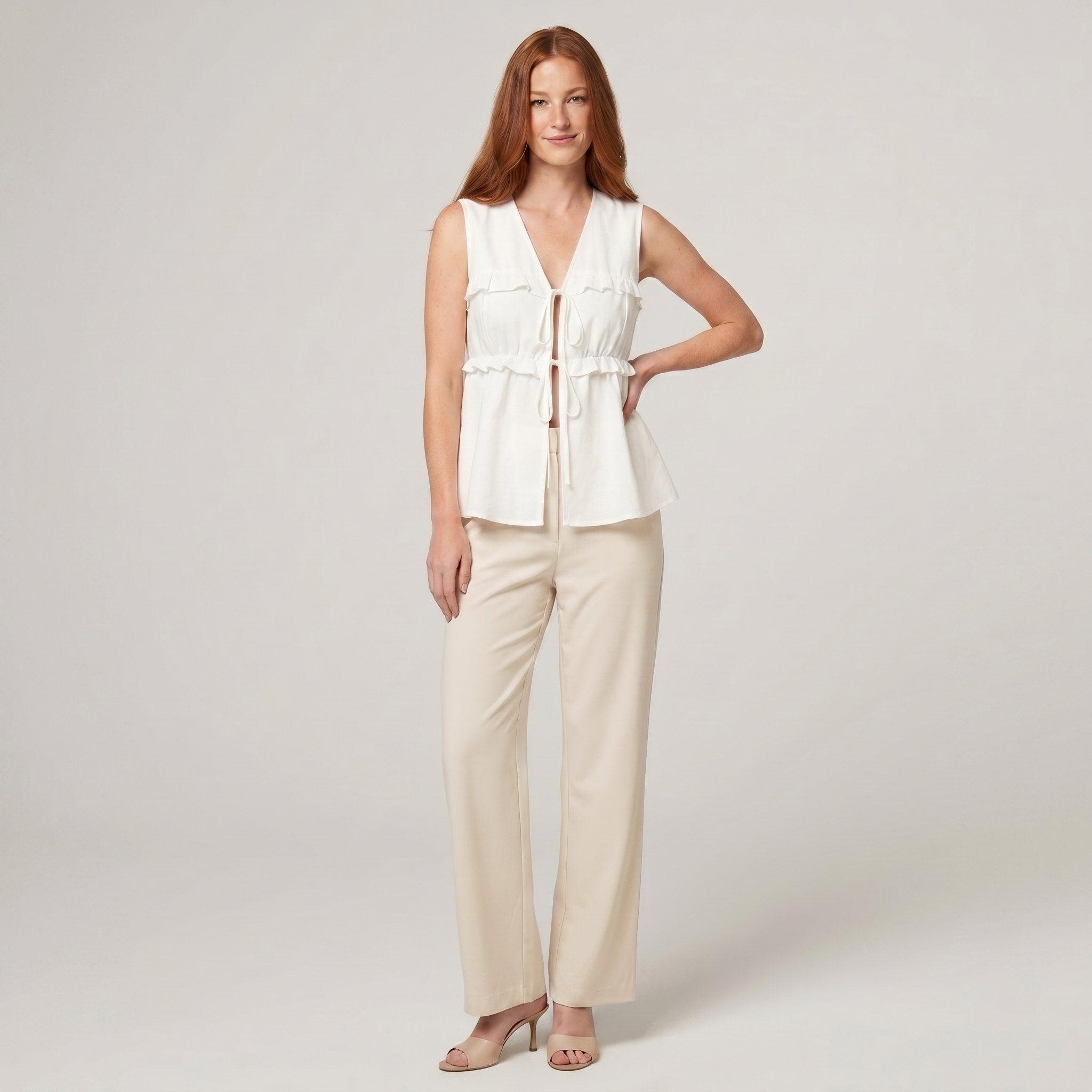 Pamela Boutique white peplum sleeveless V-neck tie-front top, model front view