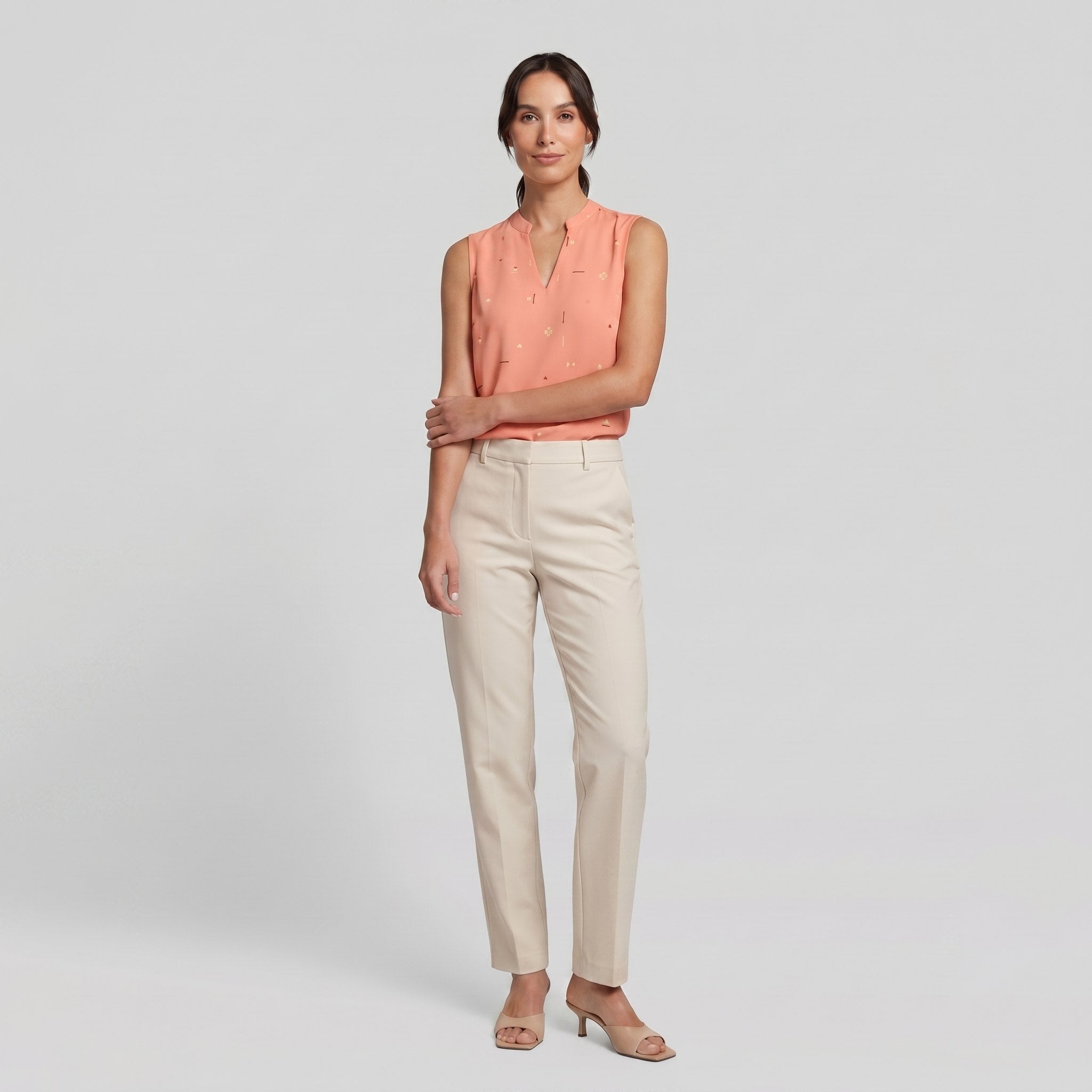 Pamela Boutique peach sleeveless V-neck blouse, model side pose