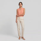 Pamela Boutique peach sleeveless V-neck blouse, model side pose