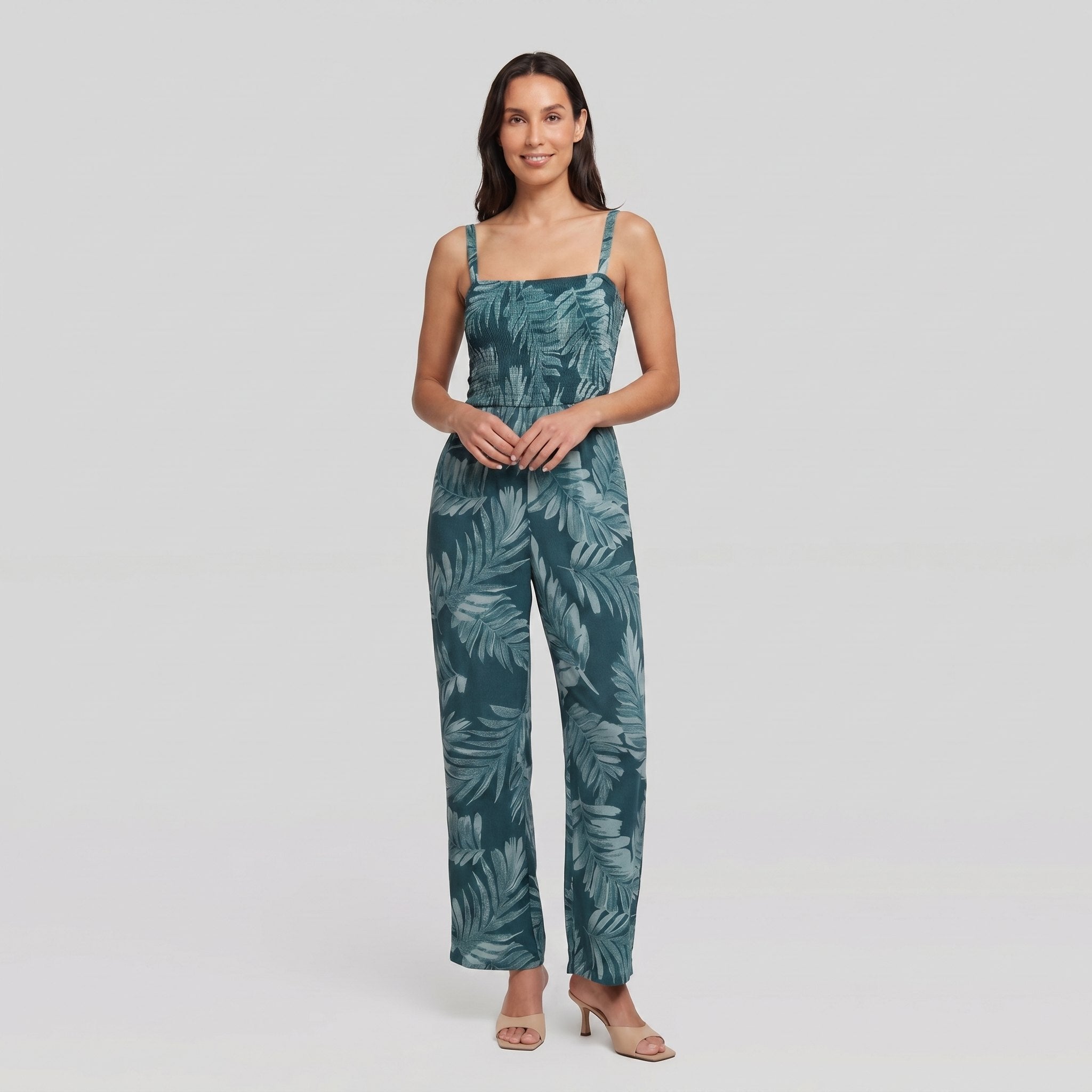 Model wearing teal wide-leg jumpsuit with smocked bodice, front view