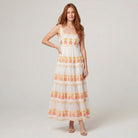 Women's white square-neck tiered maxi dress with pineapple embroidery, full-length model photo