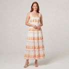 White pineapple-embroidered tiered maxi dress, front view on model