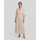 Beige tropical-print A-line maxi dress, three-quarter view on model