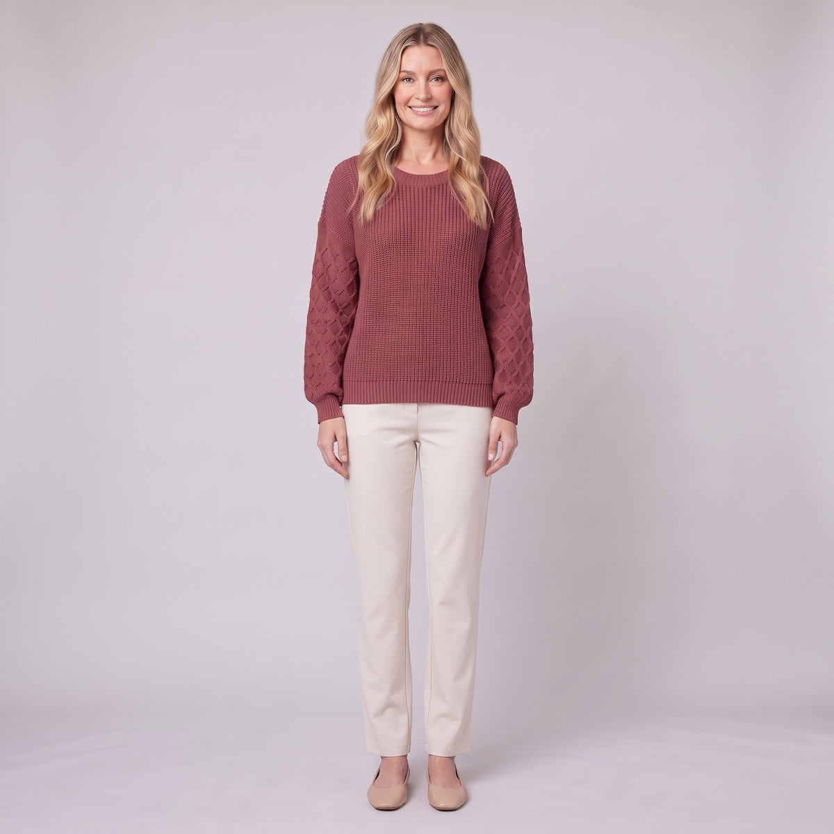 Amalie ribbed pullover in red, diamond-textured sleeves, front view on model