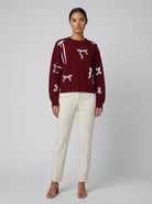Burgundy knit jumper with scattered bows, view 1
