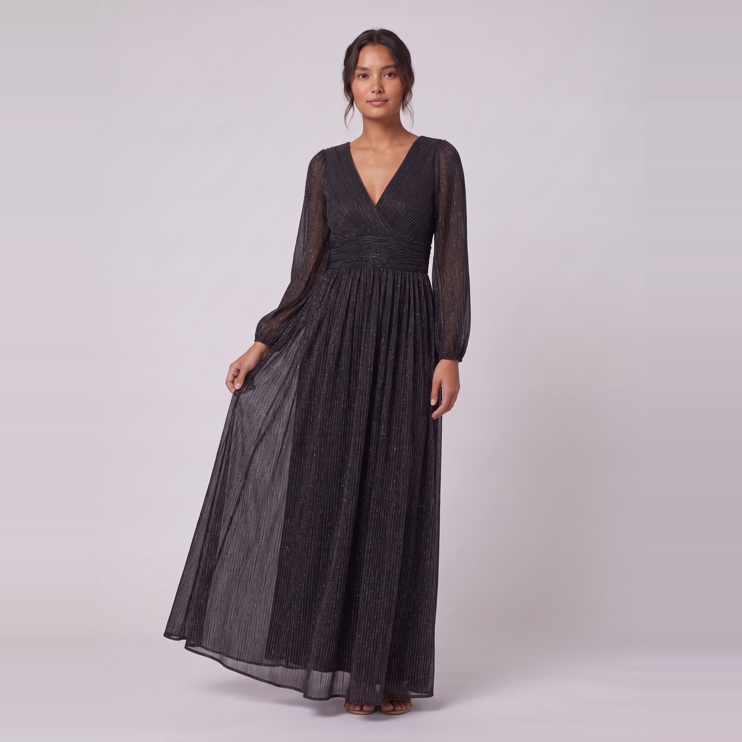 Brym black glitter gown holding the skirt, standing view