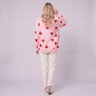 Cerise strawberry cardigan in pink, back view showing scattered strawberry pattern