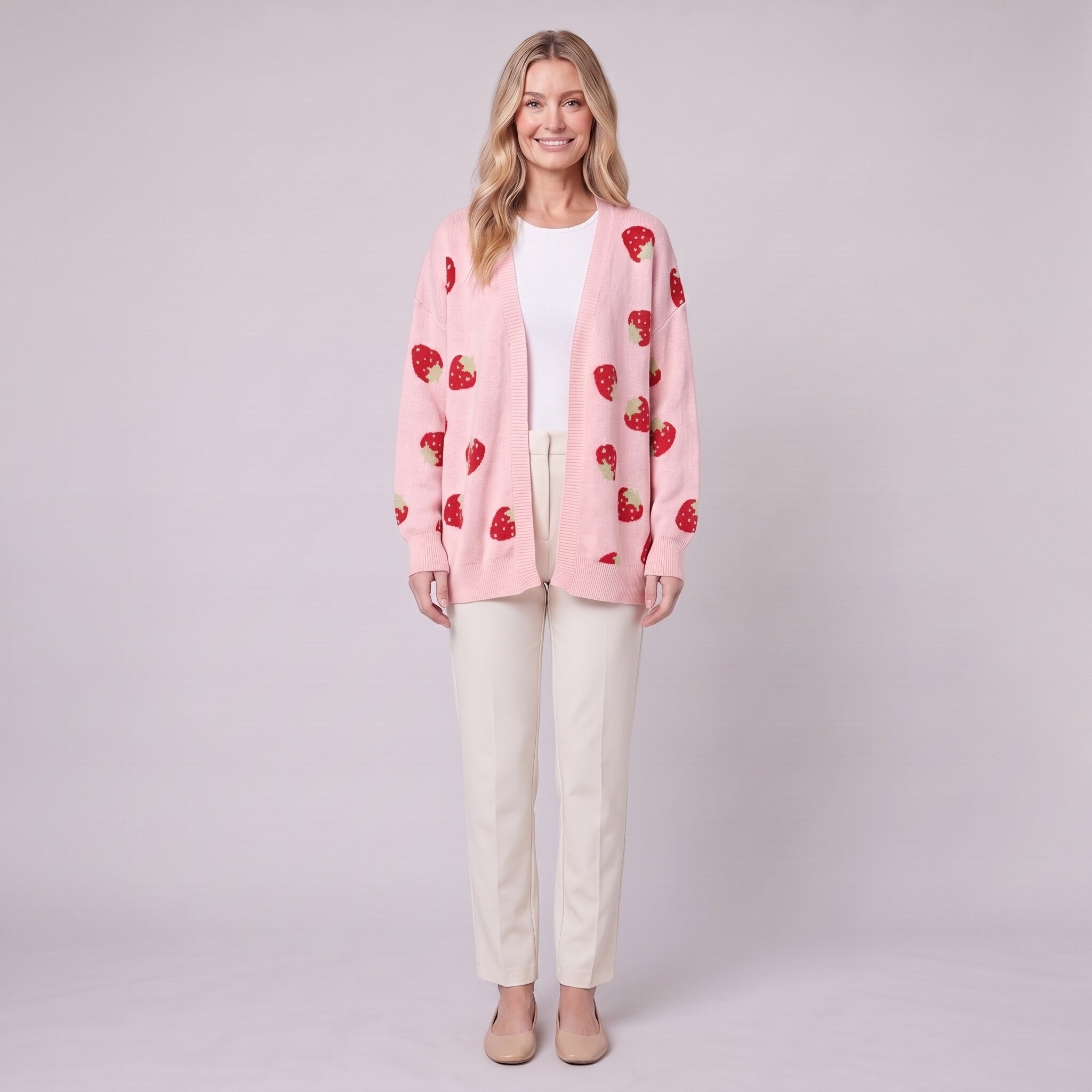 Cerise strawberry open front cardigan in pink, front view on model with cream trousers