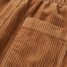 Cielle corduroy trousers fabric detail, wide-wale corduroy close-up in tobacco brown