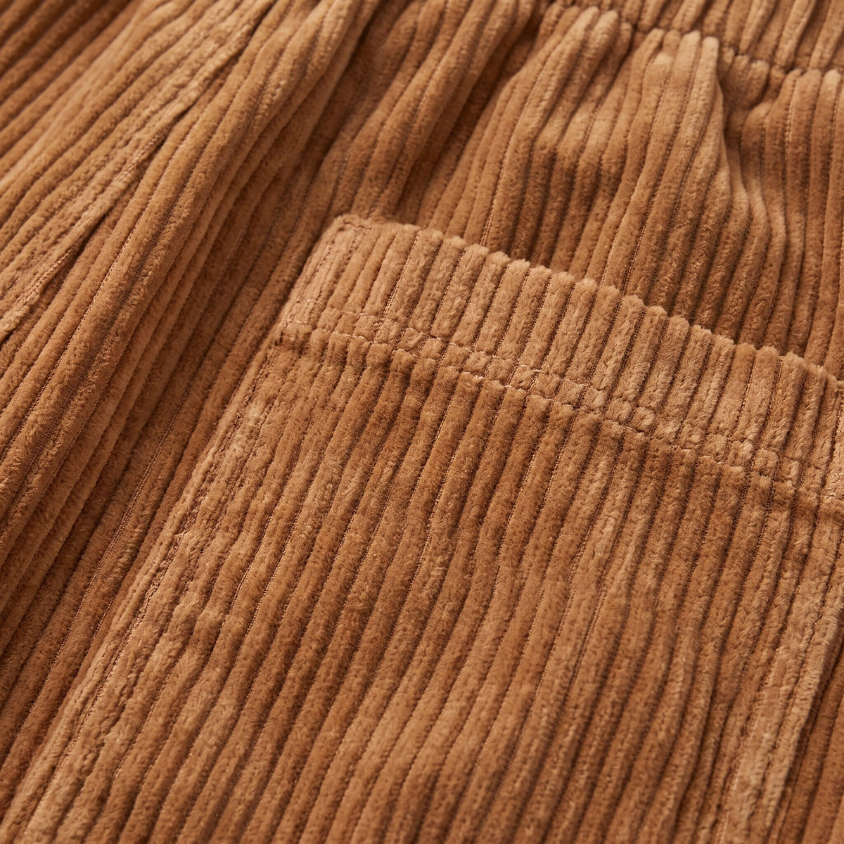 Cielle corduroy trousers fabric detail, wide-wale corduroy close-up in tobacco brown