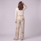 Evadne printed wide leg trousers in beige marble print, back view on model