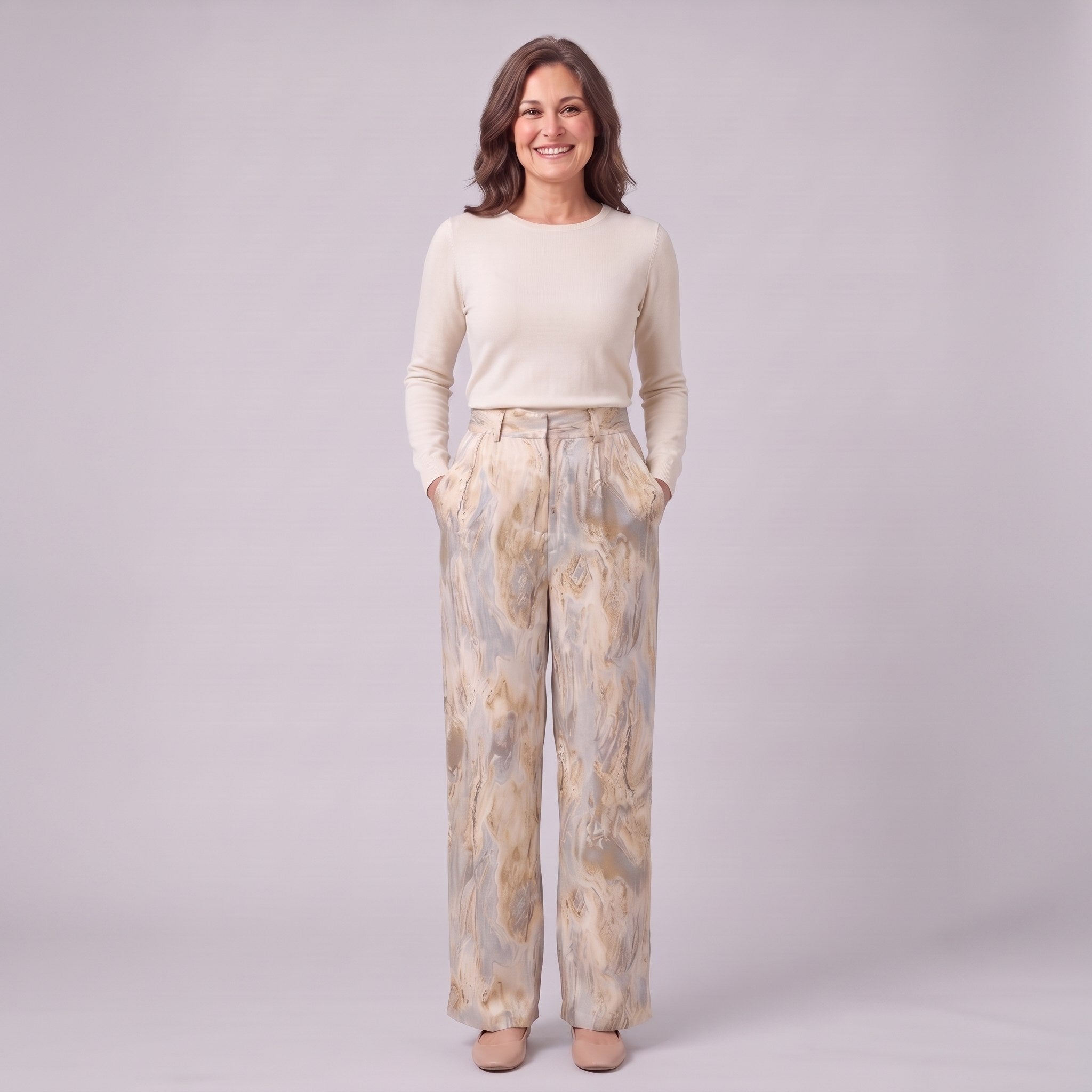 Evadne printed wide leg trousers in beige marble print, full-length view with hands in the pockets