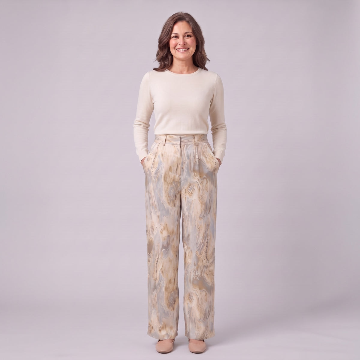 Evadne printed wide leg trousers in beige marble print, full-length view with hands in the pockets