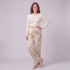 Evadne printed wide leg trousers in beige marble print, three-quarter view showing the drape