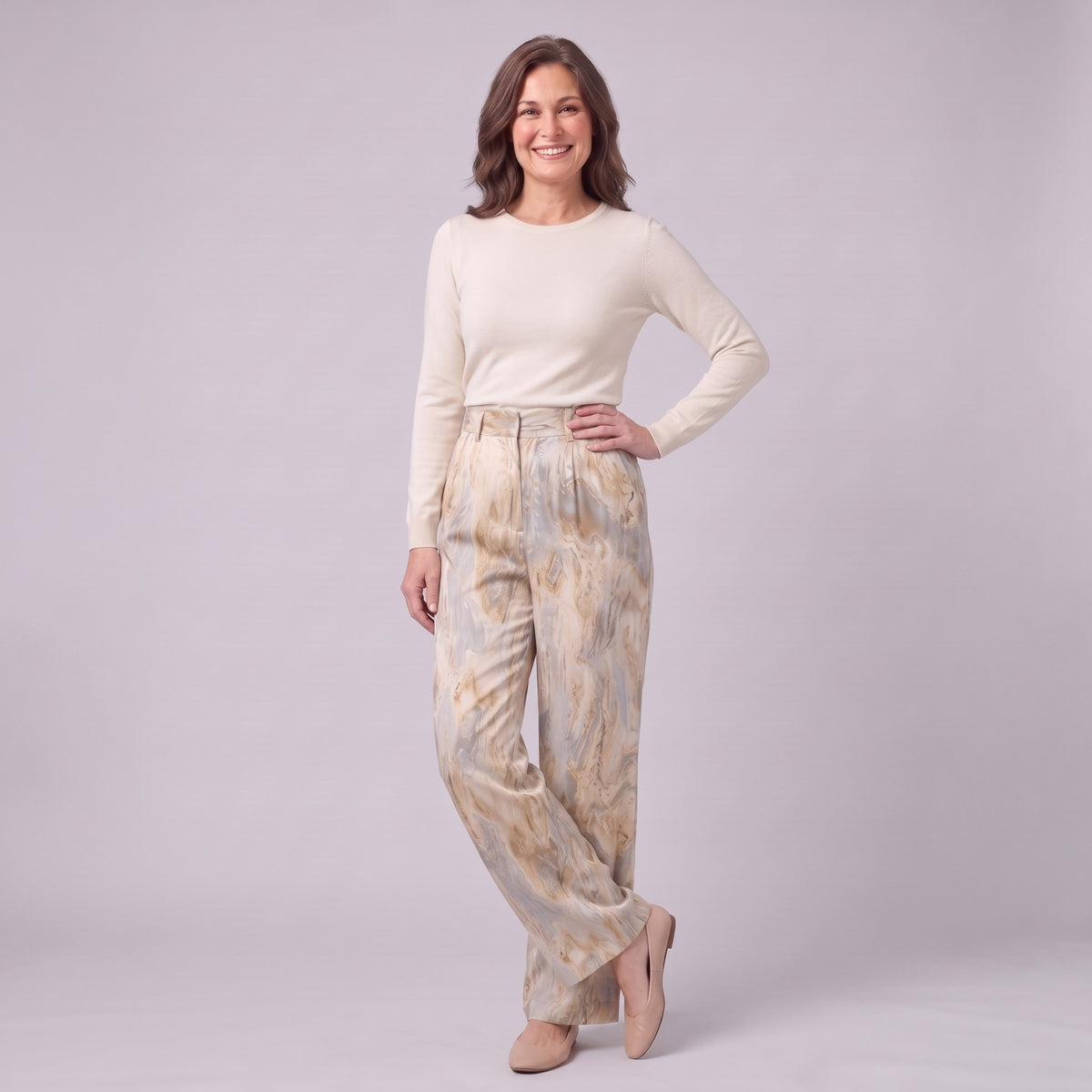 Evadne printed wide leg trousers in beige marble print, three-quarter view showing the drape