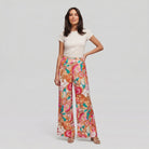 Pamela Boutique pink floral wide-leg flared trousers, model front view