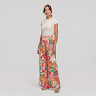 Pamela Boutique pink floral wide-leg flared trousers, model angle pose
