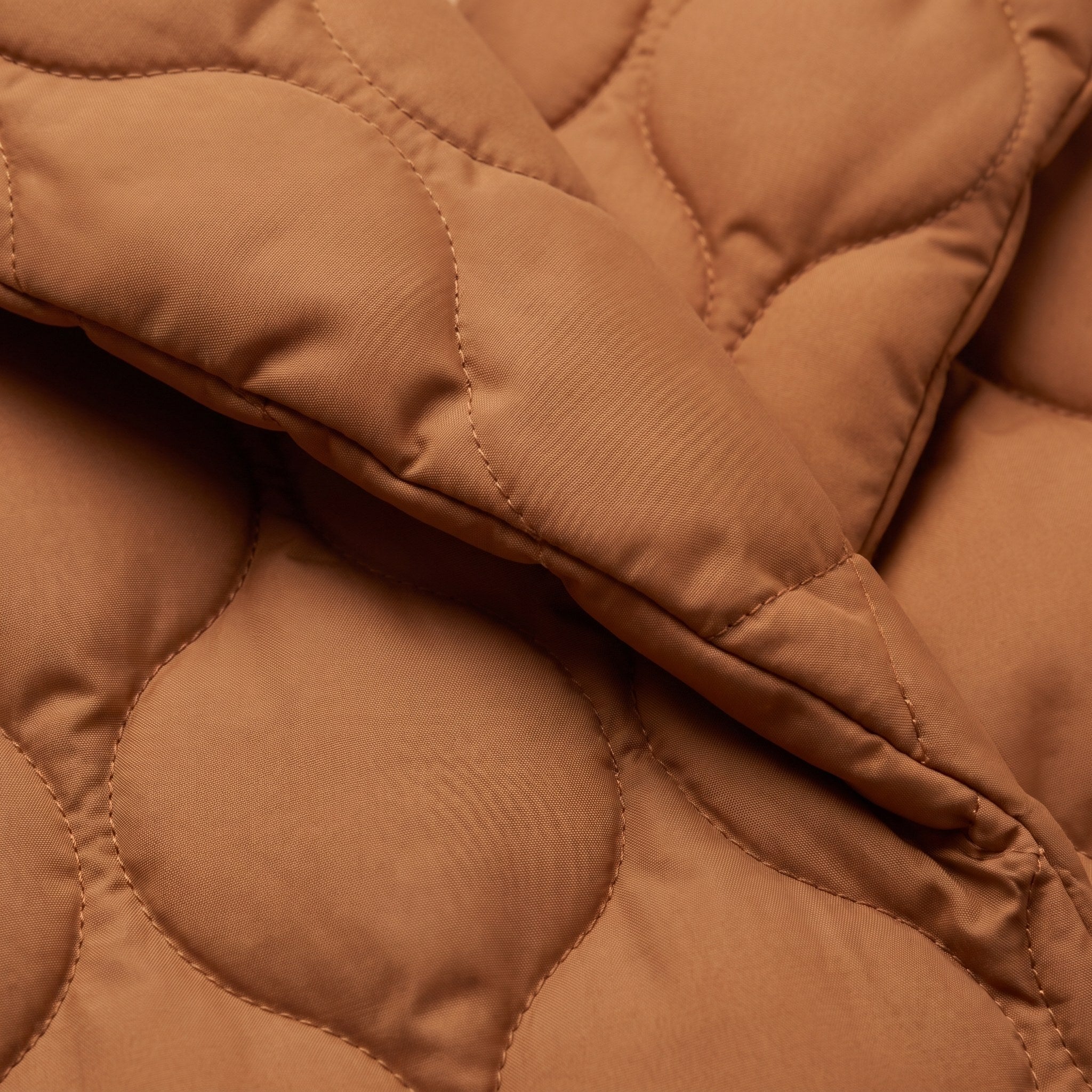 Ghislaine quilted jacket, close-up of the caramel pebble quilted fabric