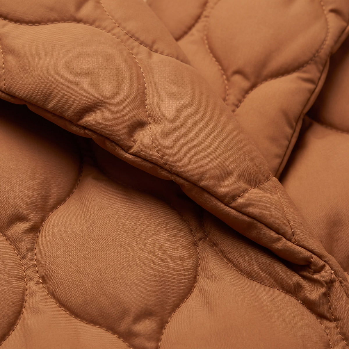 Ghislaine quilted jacket, close-up of the caramel pebble quilted fabric