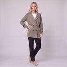 Gwenneth knit coat in taupe, three-quarter view showing the cable-knit sleeve and buckled cuff