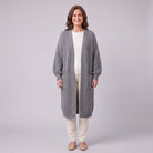 Halla longline chunky rib cardigan in grey, front view on model with cream trousers