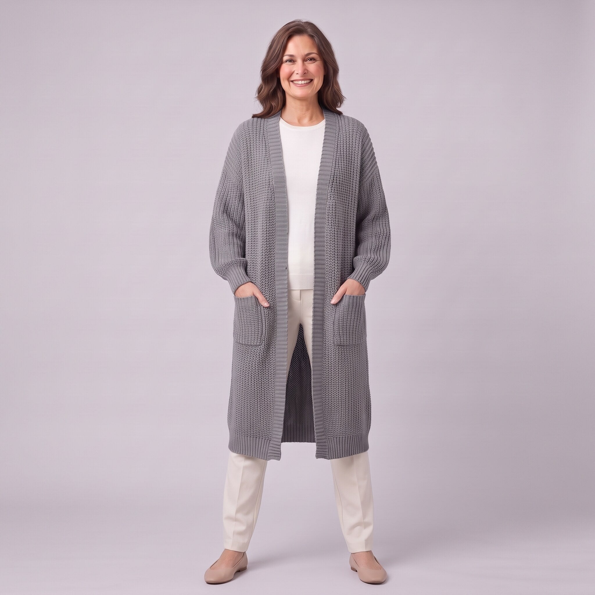 Halla longline cardigan in grey, full length front view with hands in patch pockets