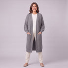 Halla longline cardigan in grey, full length front view with hands in patch pockets