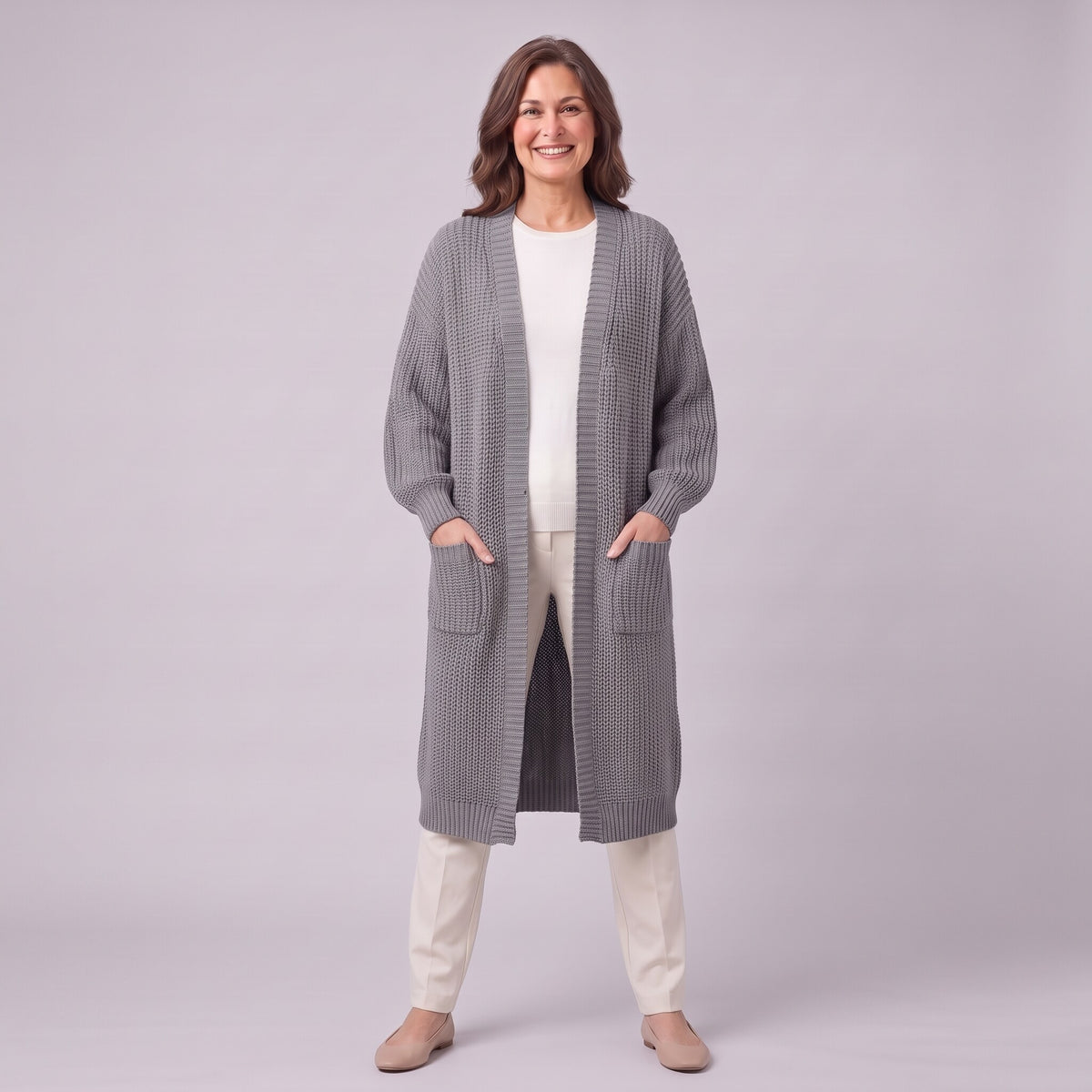 Halla longline cardigan in grey, full length front view with hands in patch pockets