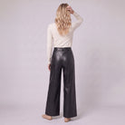 Helka faux leather wide leg trousers in black, back view on model