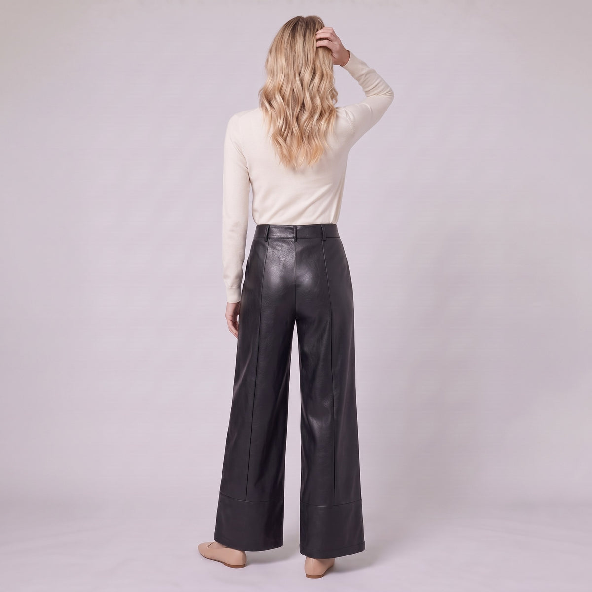 Helka faux leather wide leg trousers in black, back view on model
