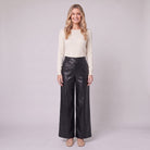 Helka faux leather wide leg trousers in black, front view on model